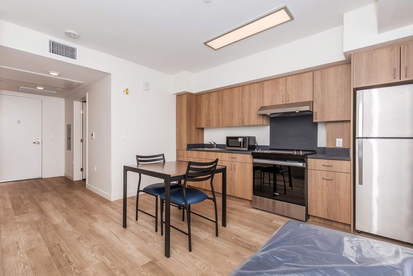 Kitchen and dining space in a furnished studio example.