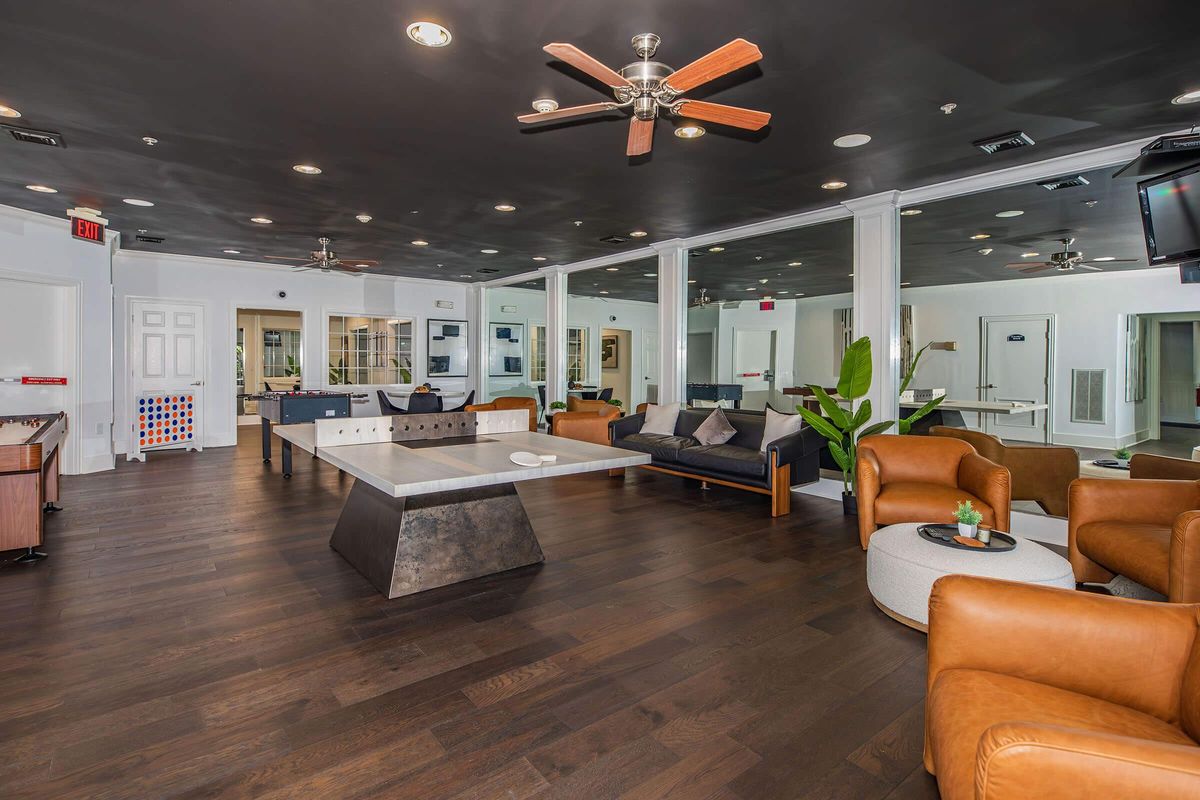 a living room filled with furniture and a flat screen tv