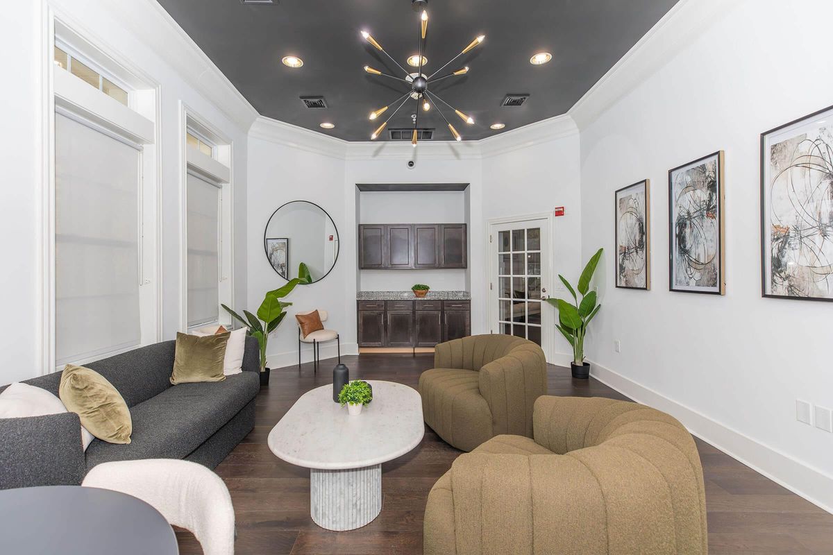 a living room filled with furniture and a flat screen tv