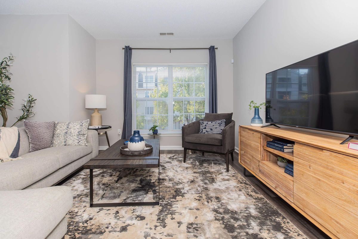 a living room filled with furniture and a flat screen tv