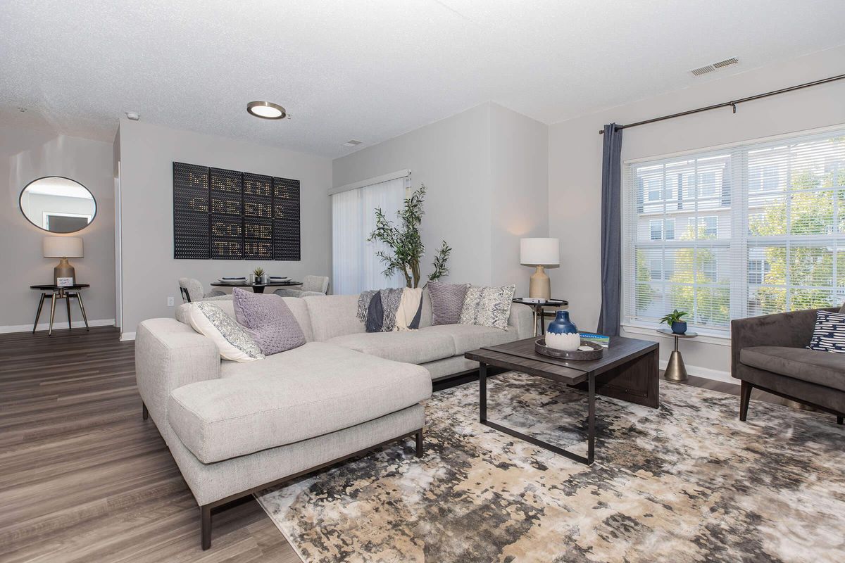 a living room filled with furniture and a large window