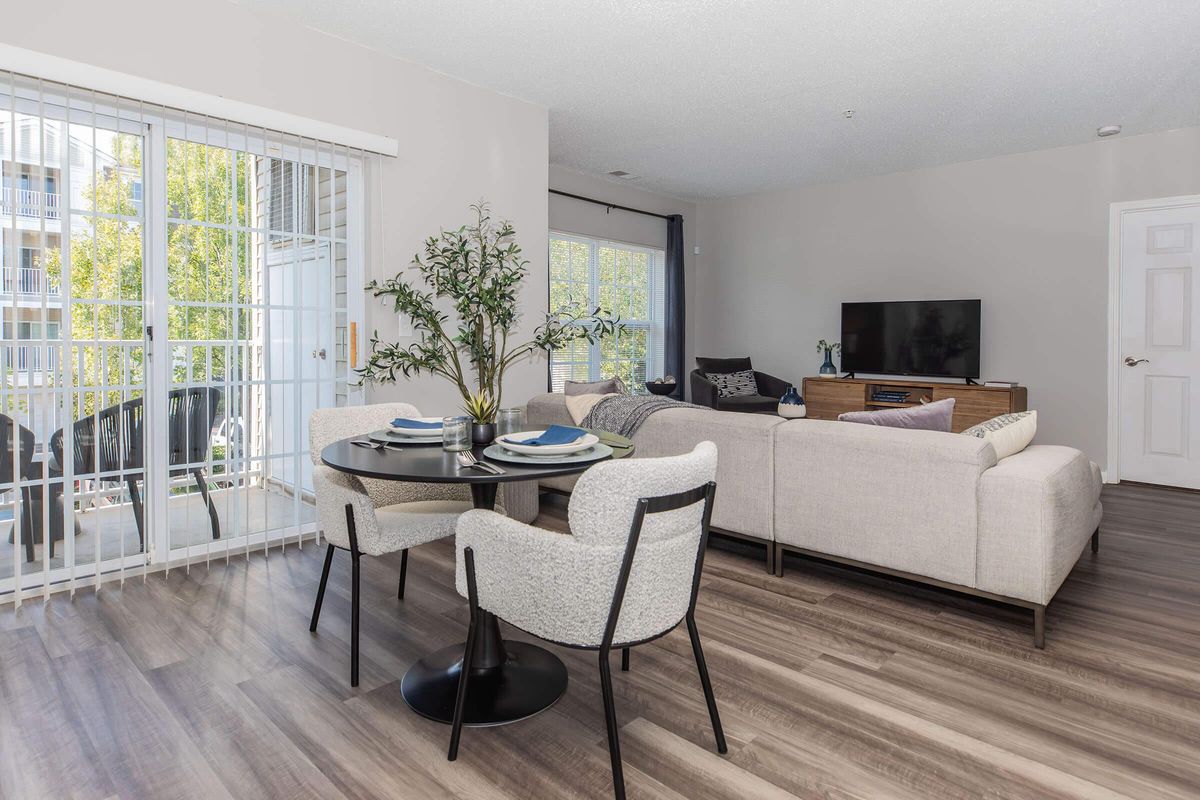 a living room filled with furniture and a large window