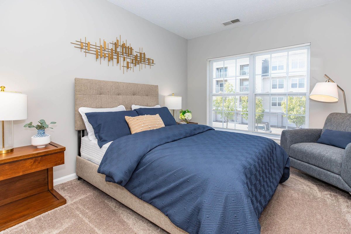 a bedroom with a bed and desk in a room