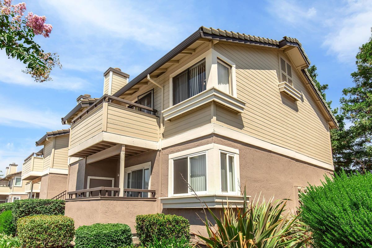 a house with bushes in front of a building