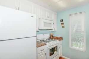 a white refrigerator freezer sitting inside of a kitchen