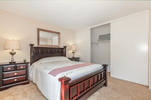 a bedroom with a bed and desk in a small room