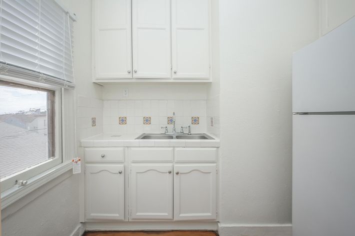 a white refrigerator freezer sitting inside of a kitchen