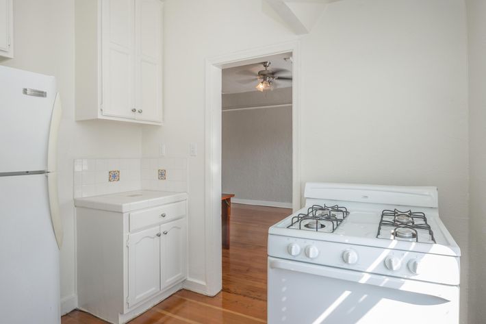 a white refrigerator freezer sitting inside of a kitchen