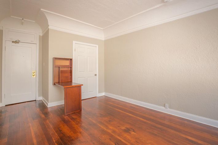 a large empty room with a wooden floor