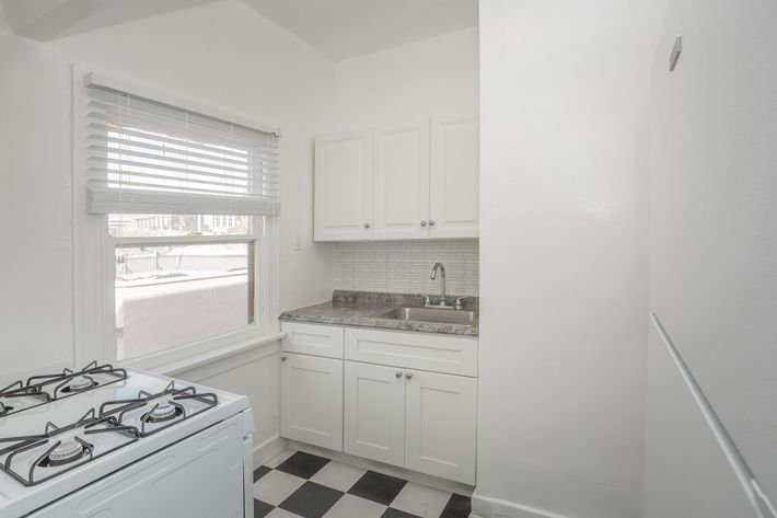 a white refrigerator freezer sitting inside of a kitchen