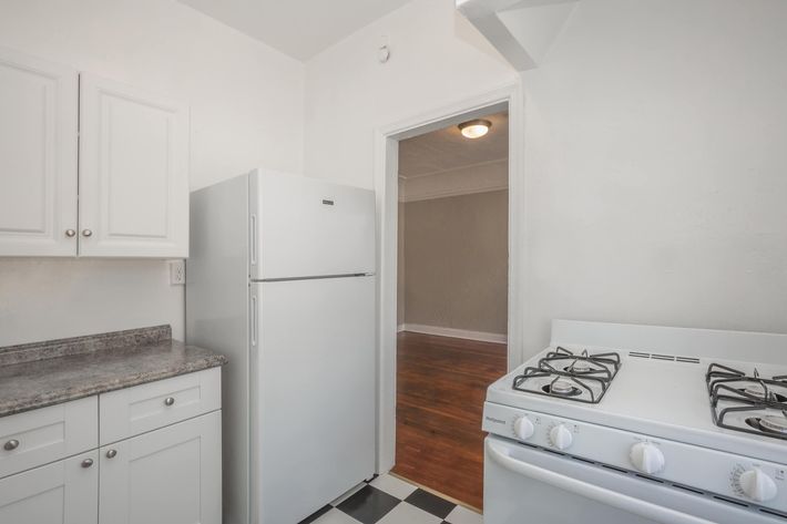 a white refrigerator freezer sitting inside of a kitchen