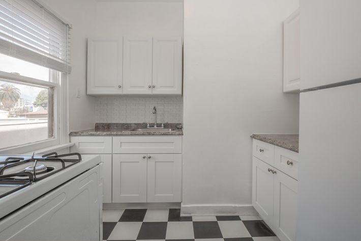 a white stove top oven sitting inside of a kitchen