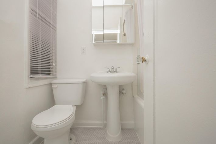 a white sink sitting next to a door