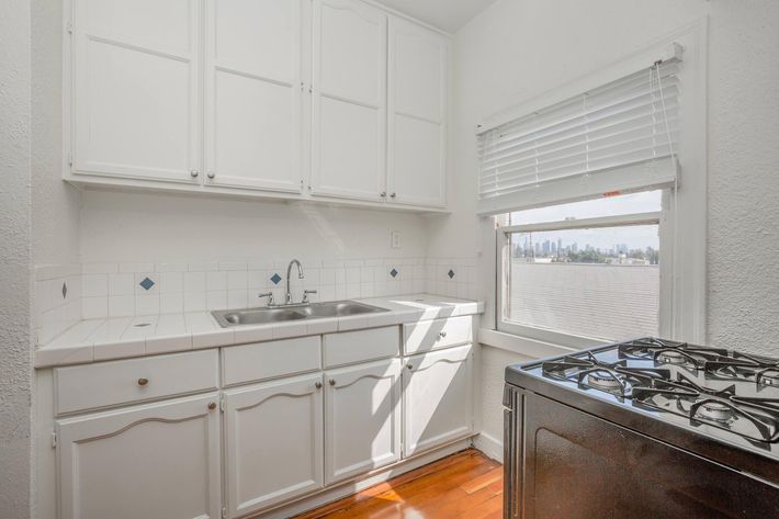 a kitchen with wooden cabinets