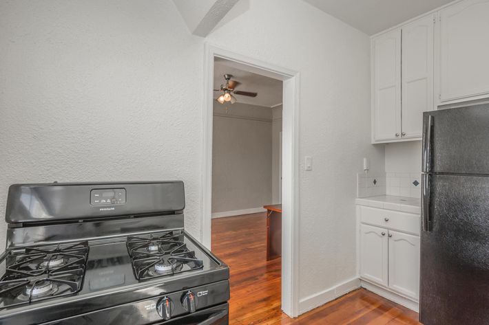 a stove top oven sitting inside of a kitchen