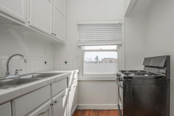 a white refrigerator freezer sitting inside of a kitchen