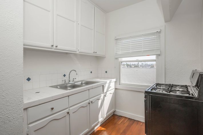 a kitchen with a sink and a refrigerator