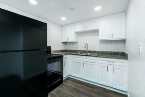 a kitchen with a stove sink and refrigerator