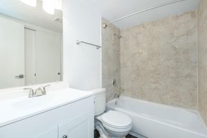 a shower that has a sink and a mirror