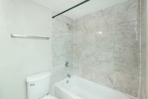 a shower that has a sink and a mirror