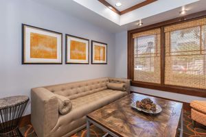 a living room filled with furniture and a large window