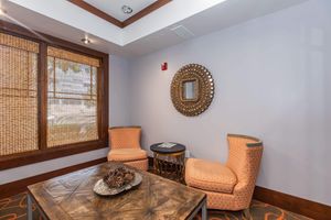 a living room filled with furniture and a large window