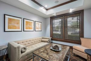 a living room filled with furniture and a large window