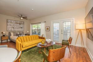 a living room filled with furniture and a large window