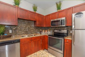 a kitchen with stainless steel appliances and wooden cabinets