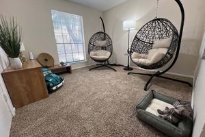 a living room filled with furniture and a tv