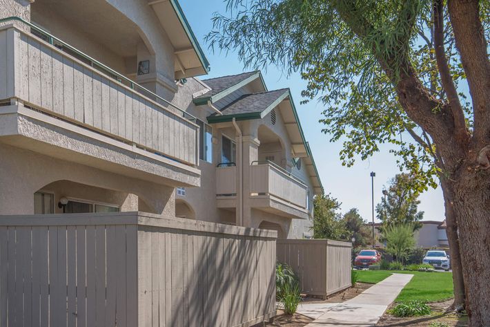 a house with a fence in front of a building