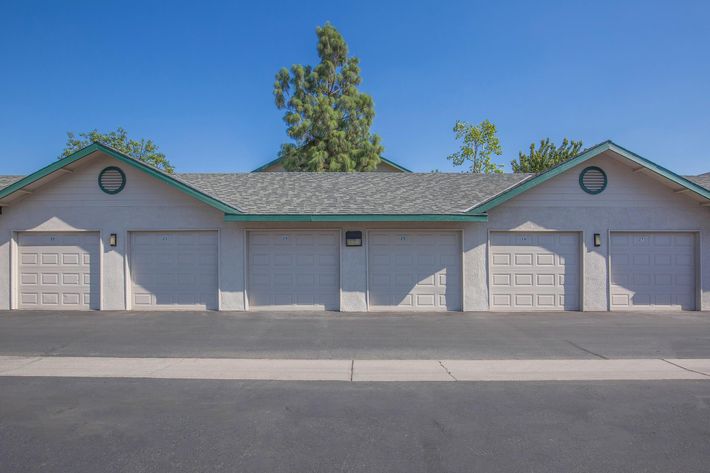 a house that has a sign on the side of a road