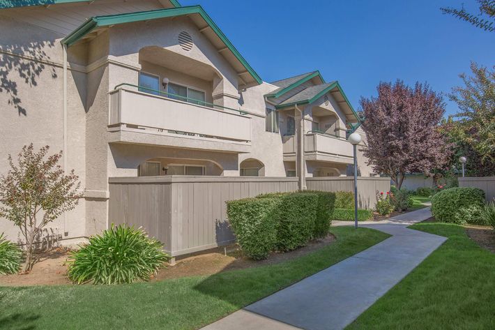 a house with a lawn in front of a building