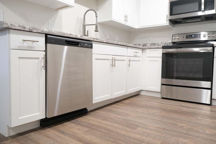 a kitchen with a stove top oven sitting inside of a refrigerator