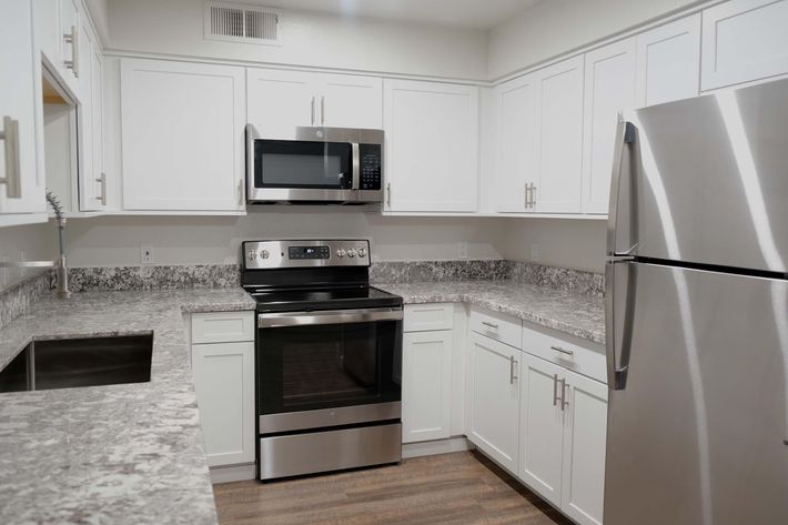 a kitchen with a stove and a refrigerator