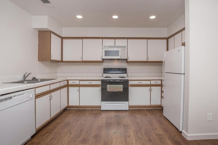 a kitchen with a stove and a refrigerator