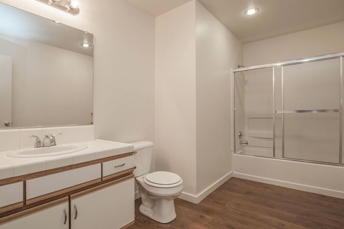 a large white tub sitting next to a sink