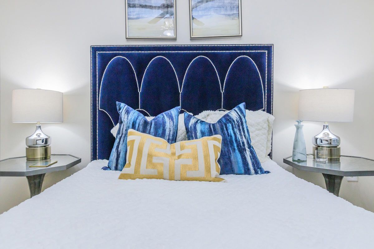 a bedroom with a bed and a mirror