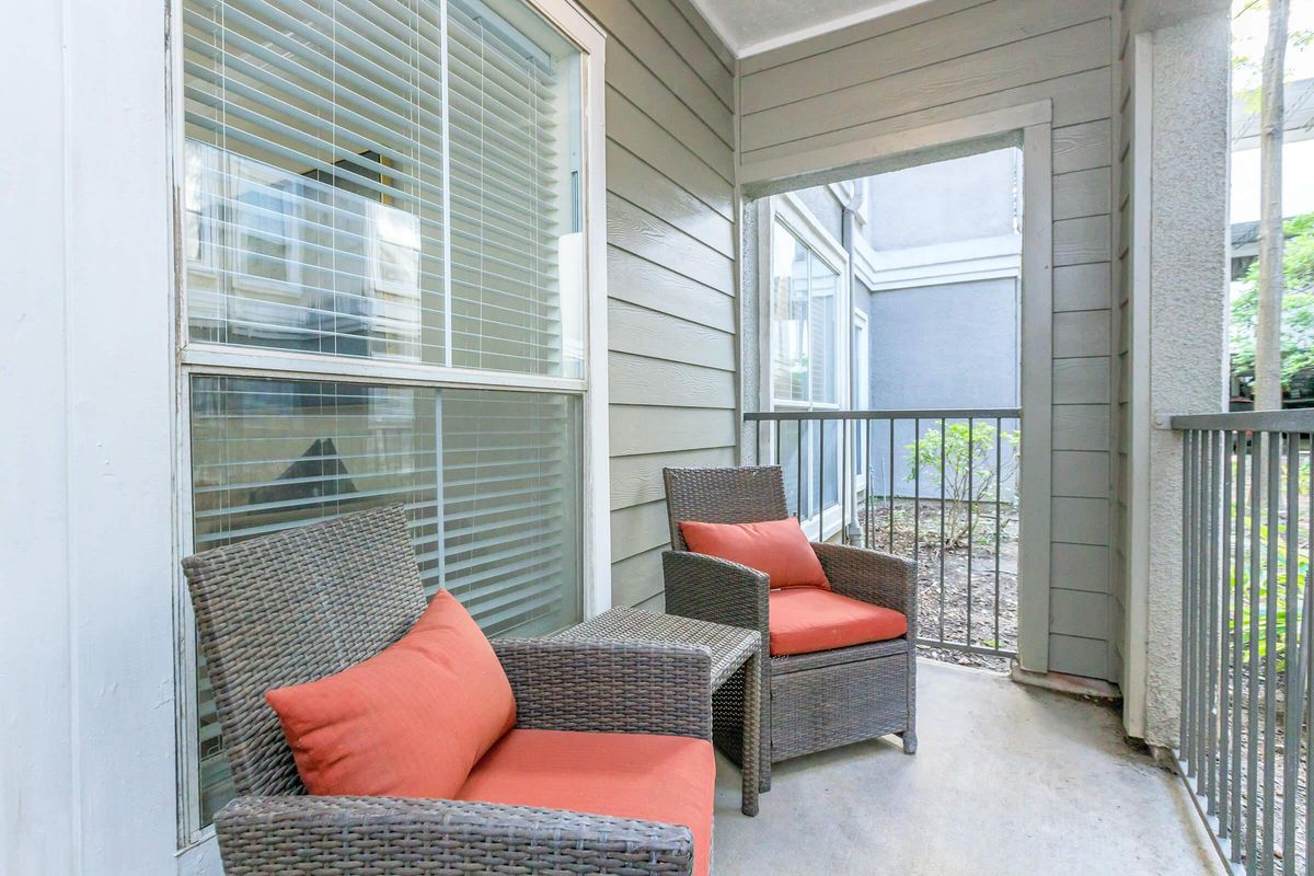 a living room filled with furniture and a large window