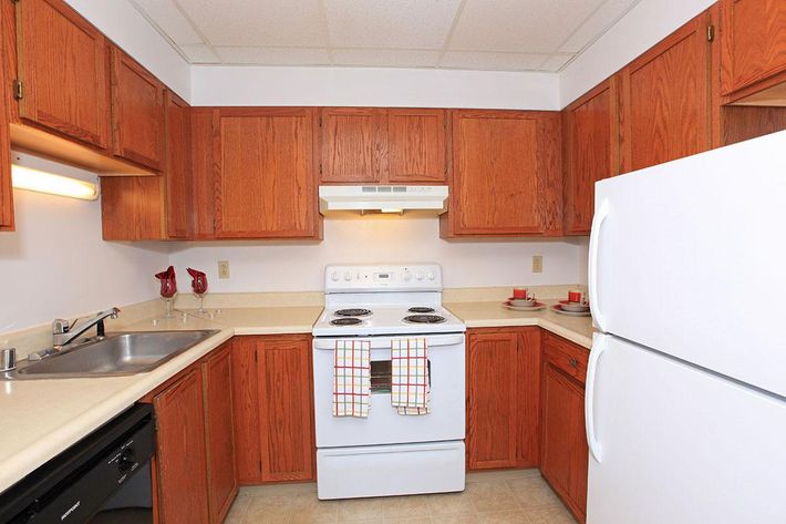 a kitchen with a stove top oven sitting inside of a refrigerator