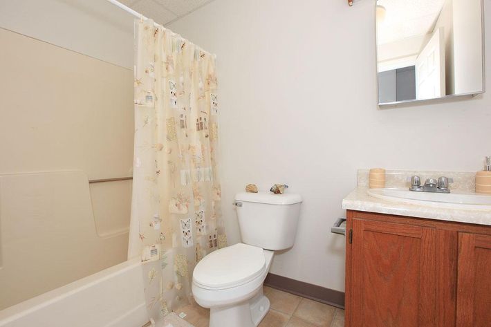 a white tub sitting next to a sink