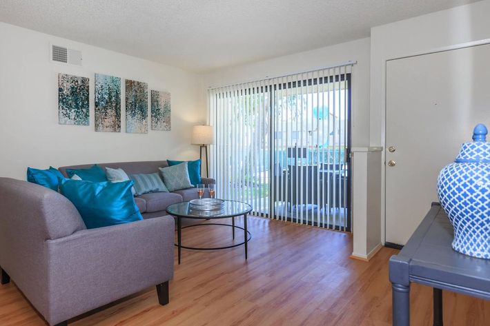 a living room filled with furniture and a flat screen tv