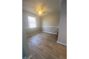 a bedroom with a wooden floor