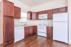 a kitchen with a stove and a refrigerator