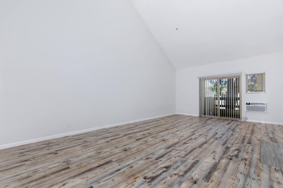 a bedroom with a building in the background