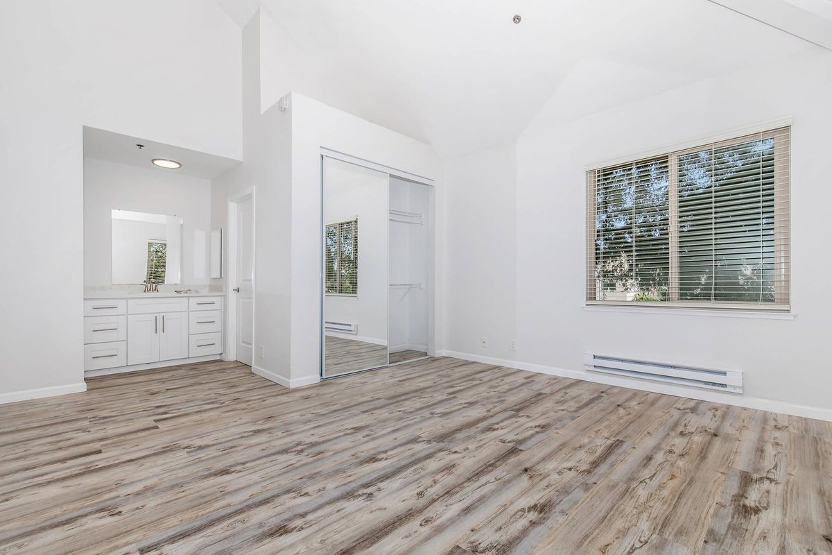 a bedroom with a building in the background