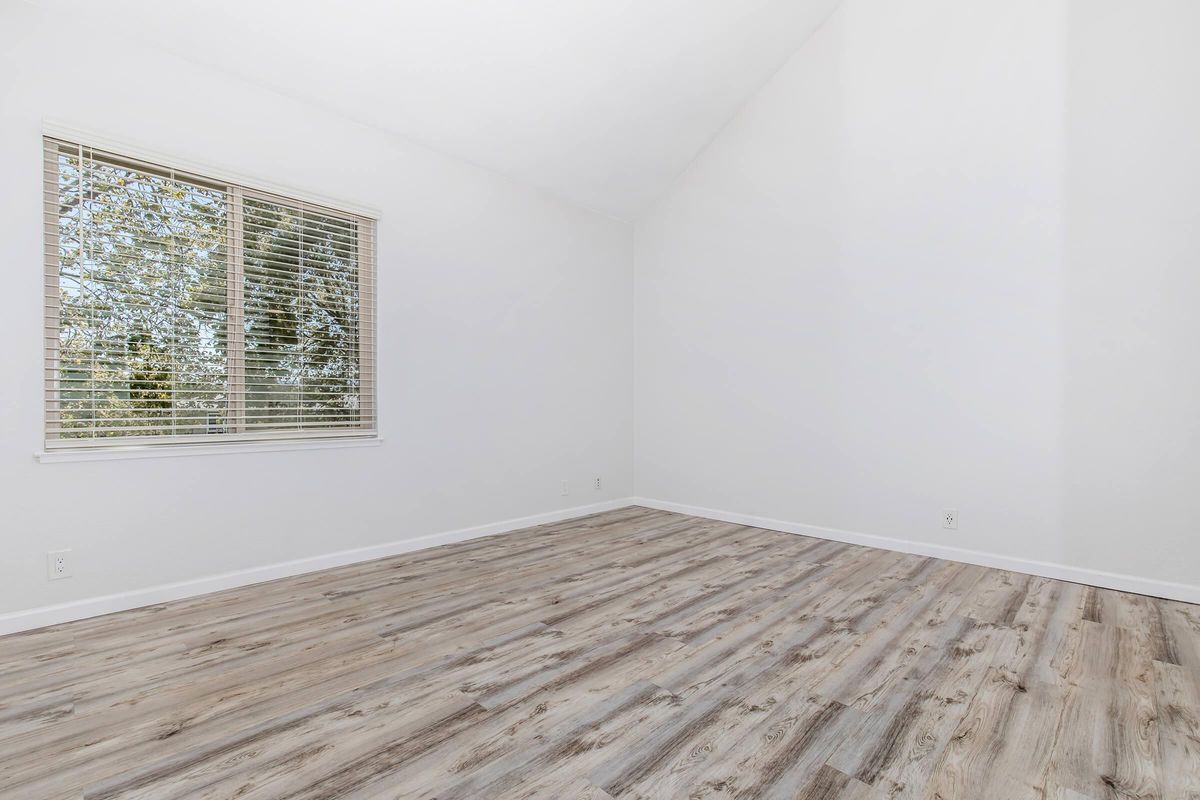 a bedroom with a building in the background