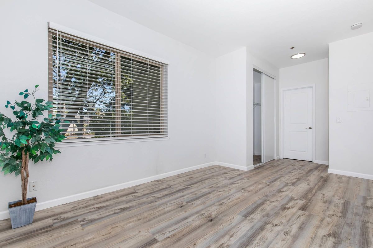 a bedroom with a building in the background