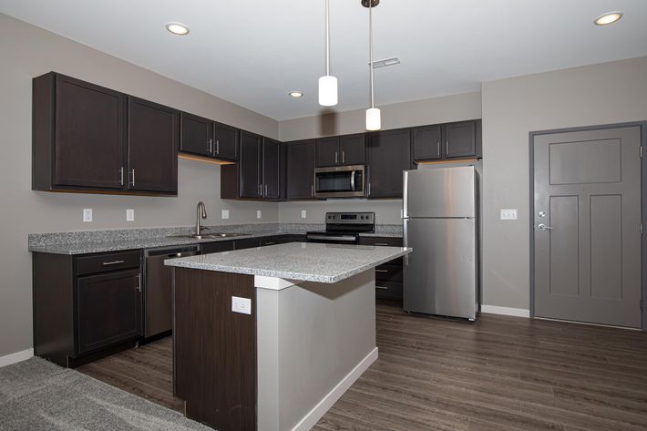 a large kitchen with stainless steel appliances