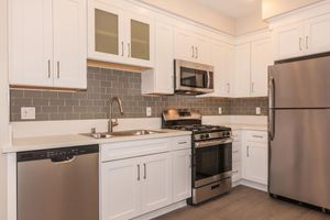 a white refrigerator freezer sitting inside of a kitchen